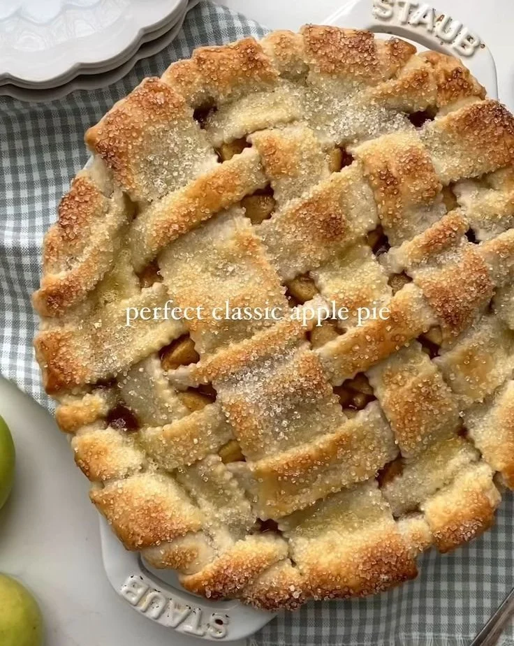 Delicious homemade apple pie with golden crust and sprinkled cinnamon