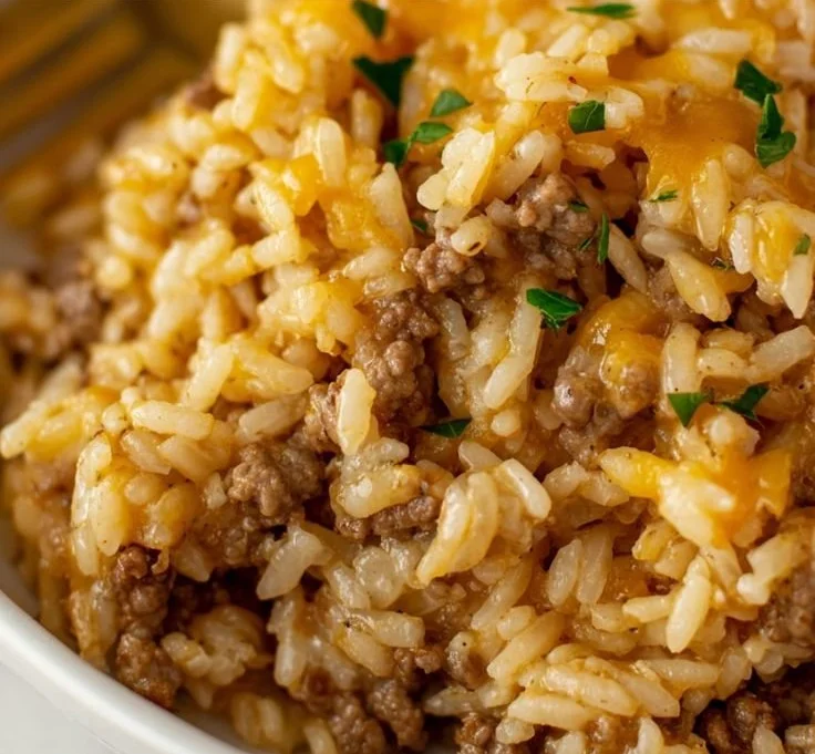 Cheesy Ground Beef and Rice Casserole topped with melted cheese in a baking dish