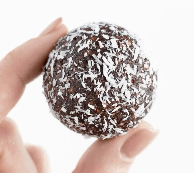 Delicious Chocolate Coconut Energy Balls stacked on a plate