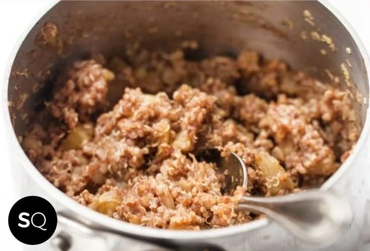Delicious bowl of Cinnamon Apple Breakfast Quinoa topped with fresh apples and cinnamon