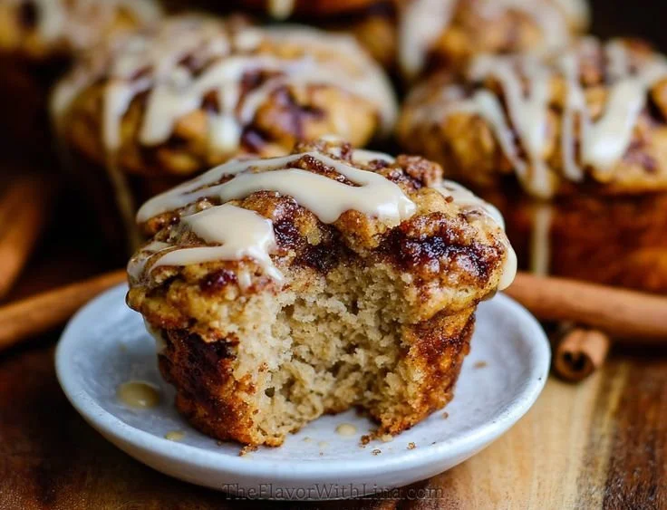 Delicious cinnamon roll protein muffins on a wooden table
