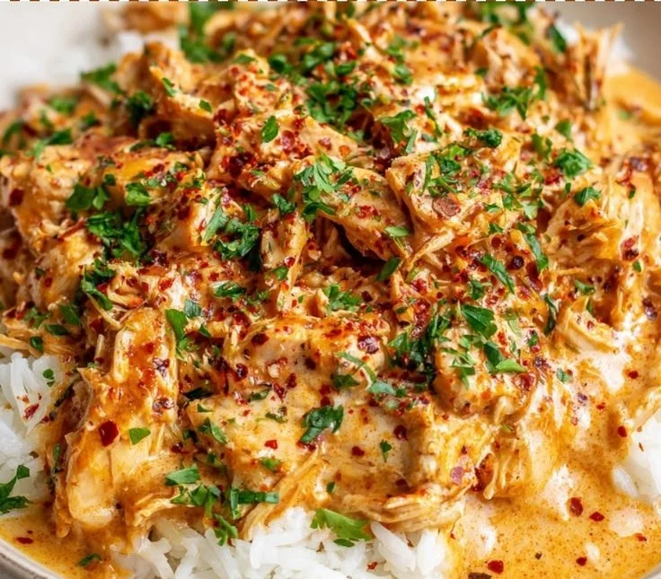Creamy Crockpot Cajun Butter Chicken served with herbs