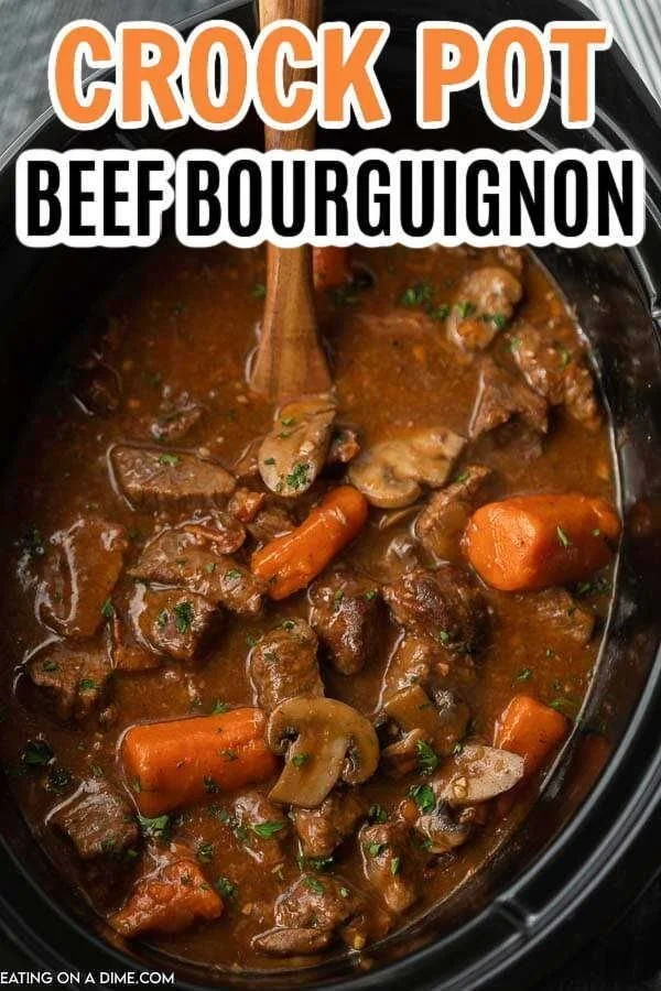 Delicious Crock Pot Beef Bourguignon served with fresh herbs and vegetables.