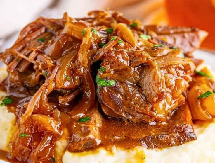 Crock Pot French Onion Pot Roast served with vegetables and herbs.