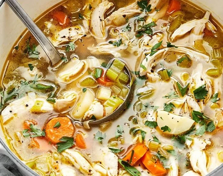 Bowl of easy homemade chicken soup with vegetables and herbs