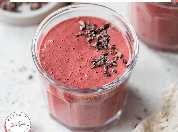 A variety of healthy breakfast smoothies in colorful glasses on a kitchen counter.