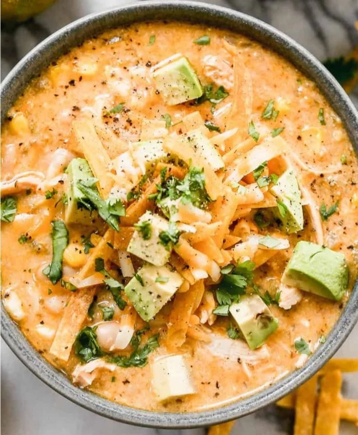 Bowl of healthy high protein white chicken chili topped with cilantro and lime
