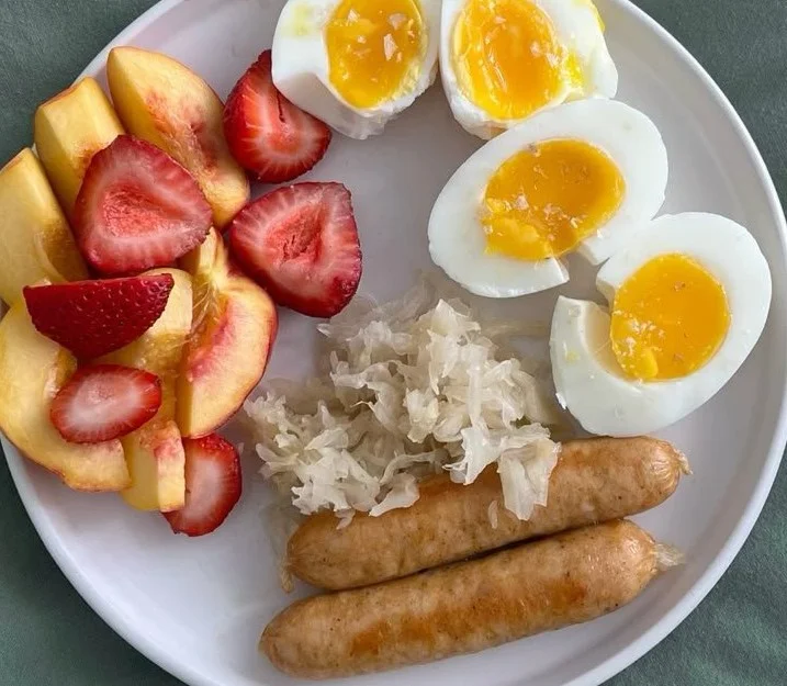 High protein chicken breakfast sausage and eggs served on a plate.