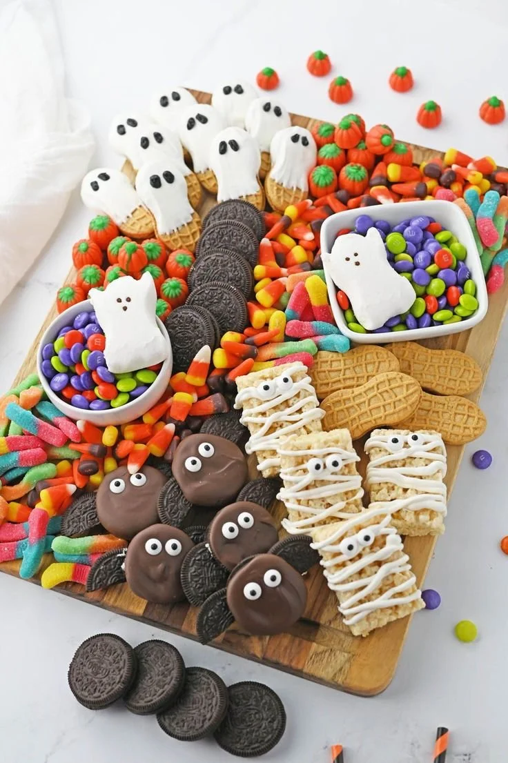 Halloween snack board with spooky treats and festive decorations