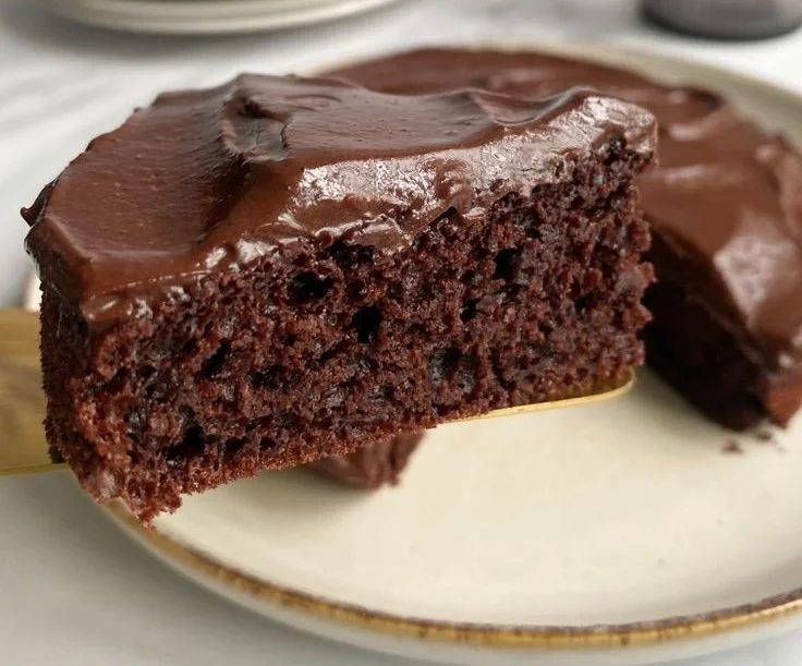 Low calorie chocolate cake slice on a plate with a fork.