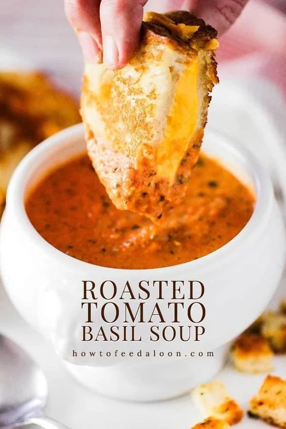 Bowl of roasted tomato basil soup garnished with fresh basil leaves