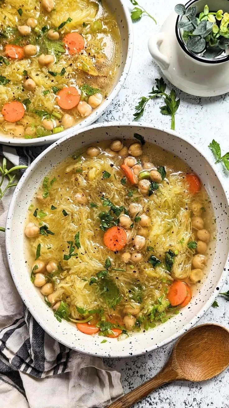 Bowl of vegan gluten-free spaghetti squash soup topped with herbs