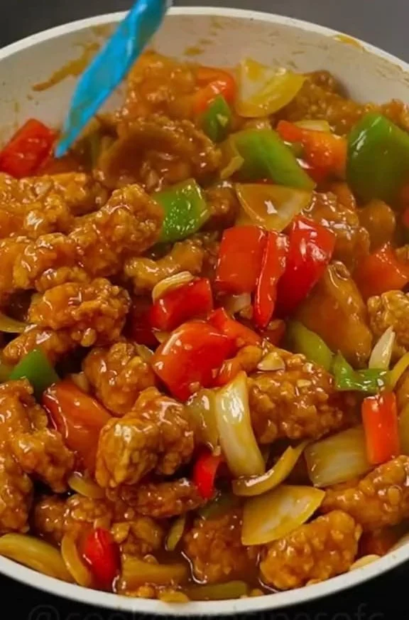 Delicious plate of Sweet & Sour Chicken garnished with vegetables
