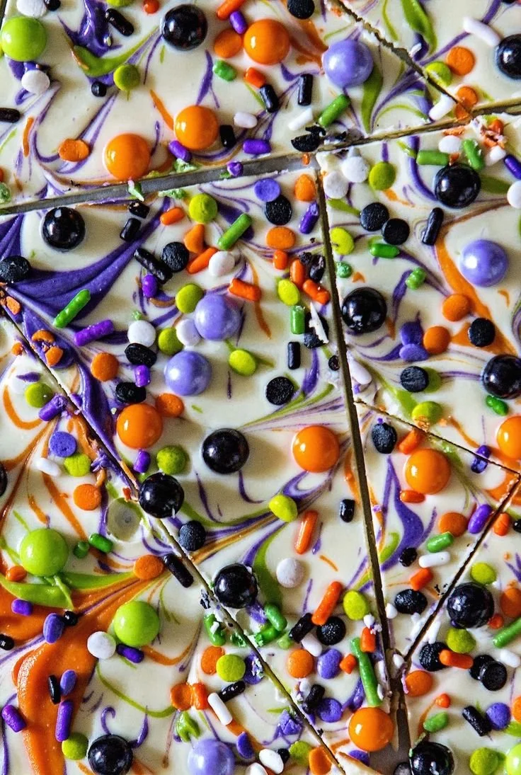 Delicious chocolate bark with nuts and dried fruits on a wooden background.