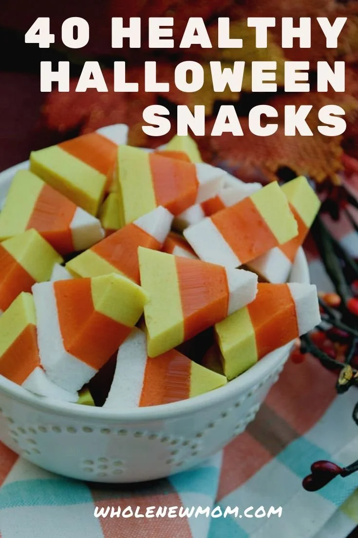 A variety of healthy Halloween treats displayed on a festive table