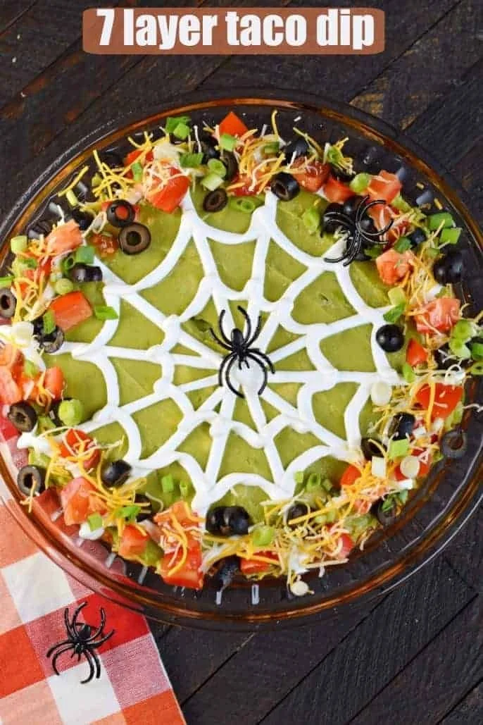 Spooky Halloween 7 Layer Taco Dip served in a festive dish for Halloween parties
