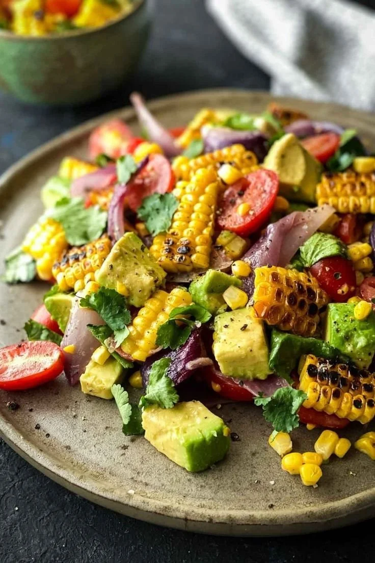 Colorful grilled corn salad with fresh vegetables and herbs