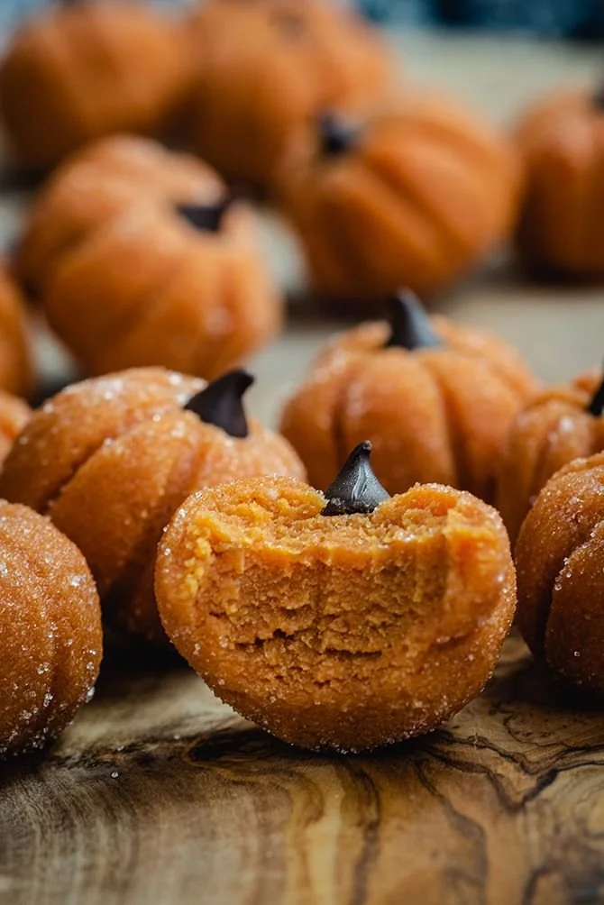 Delicious pumpkin cheesecake truffles on a rustic wooden table